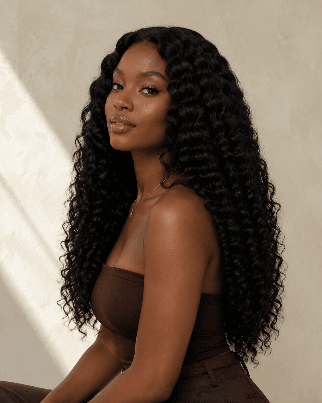 Model wearing long full dark curly hair